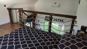 a bed in a room with a sign on the wall at Dobry Dom II in Staszów