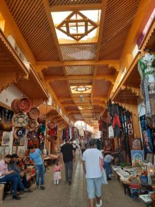 a group of people walking through a market at DARY in Fez