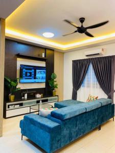 a living room with a couch and a flat screen tv at The Green Semenyih Homestay Family Suites 14 PAX in Semenyih