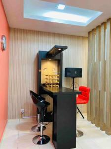 a bar in a room with two chairs and a table at The Green Semenyih Homestay Family Suites 14 PAX in Semenyih