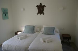 A bed or beds in a room at Extravagant Ibiza Villa Casa Tranquila Sargamassa 5 Bedrooms Fantastic Sea Views Private Pool Santa Eulalia