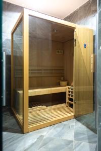 a large wooden cabinet with a glass door at Aya Sophia Villa Garden Hotel in Dar es Salaam