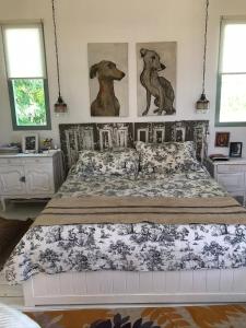 a bedroom with a bed with two dogs on the wall at Capilla-Casa de campo in Capilla del Señor +28 photos
