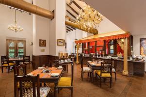 a restaurant with tables and chairs and a bar at Storii By ITC Hotels, Shanti Morada Goa in Calangute
