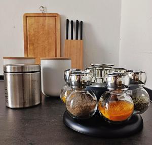 a counter with four glass containers of food and spices at La casetta al mare in Palermo