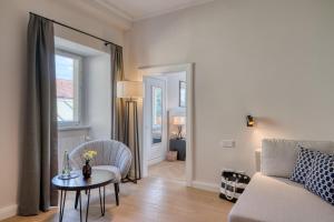 a living room with a couch and a table at Hotel Eisenhut in Rothenburg ob der Tauber