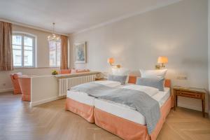a bedroom with a large bed and a living room at Hotel Eisenhut in Rothenburg ob der Tauber