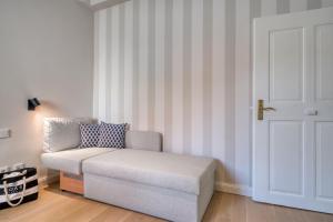 a living room with a chair and a door at Hotel Eisenhut in Rothenburg ob der Tauber