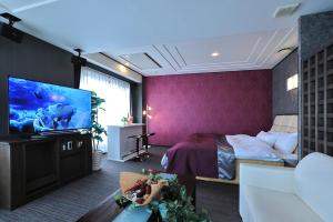 a hotel room with a bed and a flat screen tv at Hotel Water Gate Nagoya - Love Hotel for couple - in Nagoya