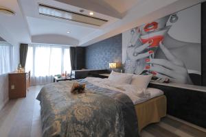 a bedroom with a bed with a painting on the wall at Hotel Water Gate Nagoya - Love Hotel for couple - in Nagoya