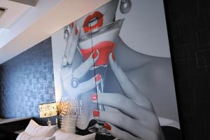 a poster of a woman holding a glass of wine at Hotel Water Gate Nagoya - Love Hotel for couple - in Nagoya