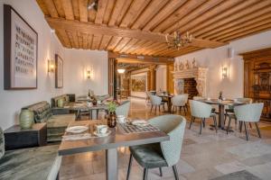 a living room with tables and chairs and a fireplace at Hotel Eisenhut in Rothenburg ob der Tauber