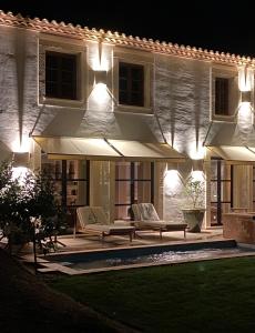 a house with a patio at night with lights at Magnifique villa dans propriété au havre de paix in Le Plan-de-la-Tour