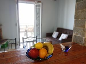 a bowl of fruit on a table in a living room at Xigia hideaway - panoramic sea view house in Zakynthos Town