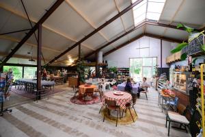 a large room with tables and people sitting at tables at Het Lage Noorden in Marrum