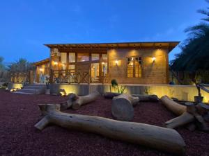 a log cabin with a log bed in front of it at Aviary AlUla in Al-ʿUla