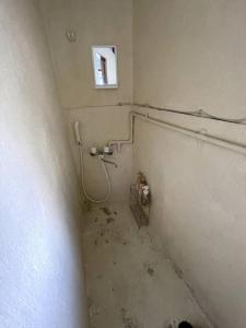 a dirty room with a shower in a wall at Ukishima bldg in Makishimachi +16 photos