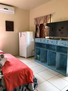 a kitchen with a blue dresser and a refrigerator at Pousada Casa do Cerrado - Alto Paraíso de Goiás in Alto Paraíso de Goiás