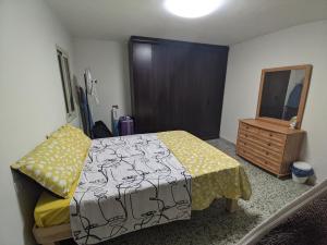a bedroom with a bed and a dresser and a mirror at 1 Bedroom house we call home in Tarshīhā