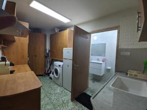 a small kitchen with a sink and a refrigerator at 1 Bedroom house we call home in Tarshīhā