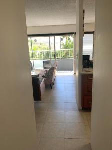 a hallway of a house with a living room and a kitchen at Ocean and Mountain View Condo - Free Reserved Parking in Honolulu
