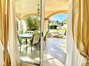 a sliding glass door to a patio with a table at Villa Libelula in L'Ametlla de Mar