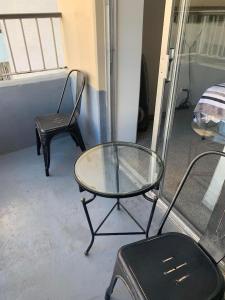 a glass table and a chair in a room at Ocean and Mountain View Condo - Free Reserved Parking in Honolulu