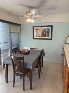 a kitchen and dining room with a table and chairs at Ocean and Mountain View Condo - Free Reserved Parking in Honolulu
