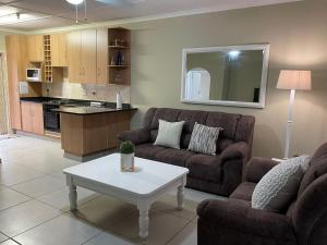 a living room with a couch and a table at Sea Casa in Scottburgh