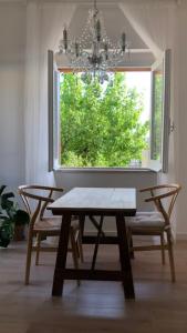a table and chairs in a room with a window at Casa giardino santadi in Santadi