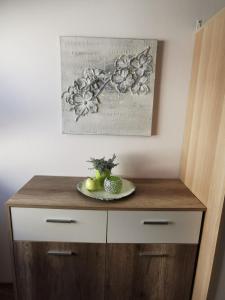 a wooden cabinet with a plate of fruit on top of it at 2,5 Zimmer Wohnung Hennef Nähe Siebengebirge in Uckerath