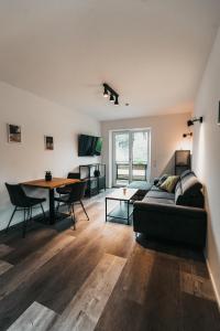 a living room with a couch and a table at Seeblick Homes in Fuschl am See