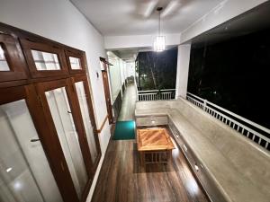 a room with a bench and a table on the floor at Heavens Holiday Resort in Kandy