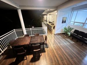 a dining room with a wooden table and chairs at Heavens Holiday Resort in Kandy