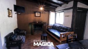 a living room with a couch and a table at Cabañas en Valle de Uco in Tunuyán