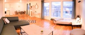 a living room with a couch and a table at Destination Senja - Skaland in Skaland