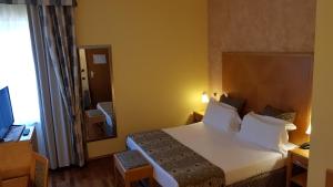 Posteľ alebo postele v izbe v ubytovaní Riviera Hotel