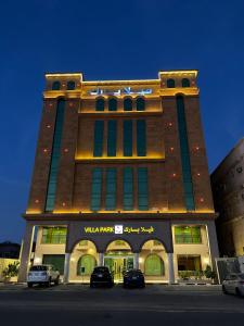 a building with cars parked in front of it at Villa Park in Al Khobar