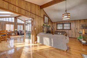 a living room with a couch and wooden walls at Bear Haven Cabin - Ski/Lake/Pool with Game Room! in Gouldsboro