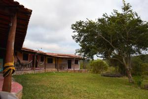 a house with a yard in front of it at Pousada Pé do Morro in Vale do Capao