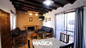 a living room with chairs and a table and a window at Cabañas en Valle de Uco in Tunuyán