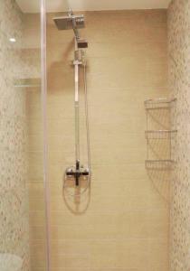 a shower with a glass door in a bathroom at 2B Gudauri Apartments in Gudauri