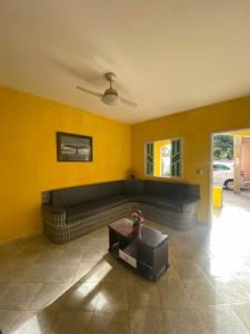 a living room with a couch and a table at Maria Dajuda in Guarapari