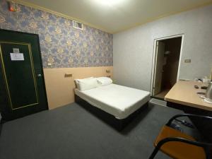 Postel nebo postele na pokoji v ubytování Rich Zone Hotel