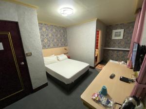 Postel nebo postele na pokoji v ubytování Rich Zone Hotel