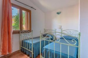 Posteľ alebo postele v izbe v ubytovaní Residence con piscina a Tanaunella a 1500 m dal mare