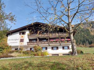 a building with a balcony with flowers on it at Haus Seeberghof by Globalimmoservice in Millstatt