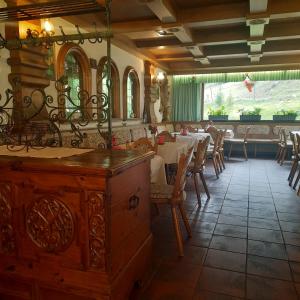 a restaurant with a dining room with tables and chairs at Landgasthaus Appartement Birkegg in Leutasch