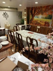 a dining room with a table with flowers on it at Aberdeen Arms Hotel Tarland in Tarland