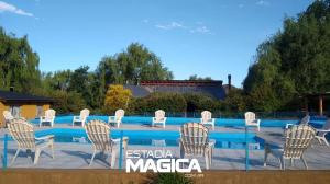 a group of chairs sitting next to a swimming pool at Cabañas en Valle de Uco in Tunuyán